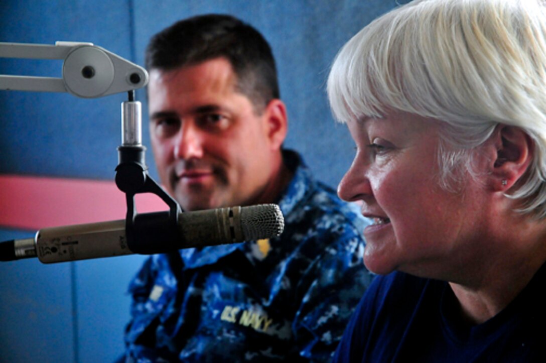 U.S. Navy  Cmdr. Michael Smith and Kathryn Walther of Project HOPE respond to questions during an interview at the local radio station about the medical team of Pacific Partnership 2011 in Lae, Papua New Guinea, May 26, 2011. 