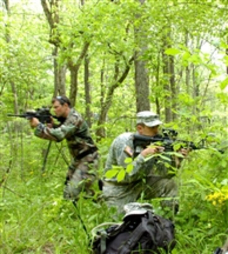 U.S. Army soldiers with the 2nd Battalion, 19th Special Forces Group look for threats while providing security along likely avenues of approach so the rest of the team can cross a trail during a foot patrol while training at Camp Atterbury Joint Maneuver Training Center, Ind., on May 15, 2011.  The unit was at Camp Atterbury for a weeklong drill.  