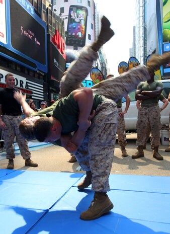 NEW YORK - Marines with 2nd Battalion, 9th Marine Regiment, demonstrate maneuvers from the Marine Corps Martial Arts Program to New Yorkers and tourists at New York City's Times Square, May 27, 2011. Various units from II Marine Expeditionary Force and Marines Forces Reserve have organized under the 24th Marine Expeditionary Unit to form the Special Purpose Marine Air Ground Task Force - New York. The Marines embarked on the Navy’s Amphibious Assault Ships, the USS Iwo Jima (LHD -7) and USS New York (LPD-21) to take part in Fleet Week New York 2011 from May 25 to June 1. The Marines will showcase the capabilities of the MAGTF, and also honor those who have served by participating in various events during the Memorial Day weekend.