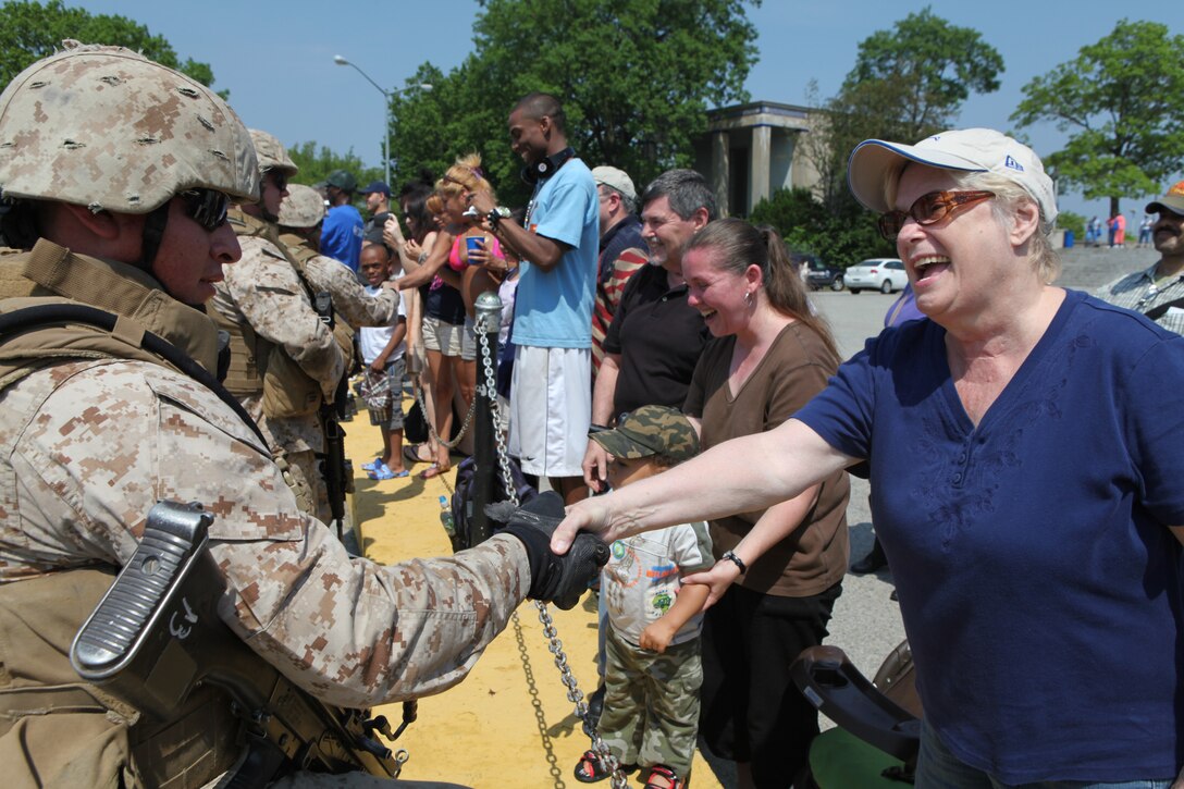 Marines with Fox Company, 2nd Battalion, 9th Marine Regiment greet New Yorkers after completing a simulated raid at Orchard Beach, May 27, 2011. Various units from II Marine Expeditionary Force and Marines Forces Reserve have organized under the 24th Marine Expeditionary Unit to form the Special Purpose Marine Air Ground Task Force - New York. The Marines embarked on the Navy's Amphibious Assault Ships, the USS Iwo Jima (LHD -7) and USS New York (LPD-21) to take part in Fleet Week New York 2011 from May 25 to June 1. The Marines will showcase the capabilities of the MAGTF, and also honor those who have served by participating in various events during the Memorial Day weekend.v