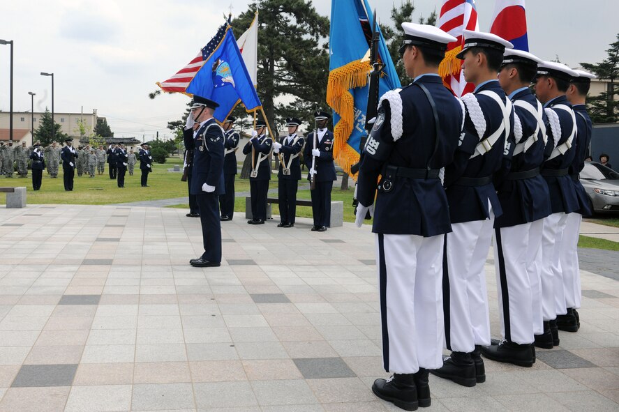 KUNSAN AIR BASE, Republic of Korea – Honor Guard members salute the flag during the playing of the national anthem here May 27. The Memorial Day ceremony paid tribute to the men and women who have given their lives while serving in the nation’s armed forces. (U.S. Air Force photo/Senior Airman Brittany Y. Bateman)