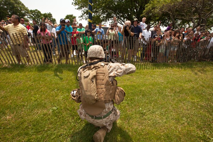 EAST MEADOW, N.Y. - Lance Cpl. Christopher Delcore demonstrates a helicopter raid at Eisenhower Park during Fleet Week New York 2011, May 28. Delcore, a Hollywood, Fla., native, is a rifleman with 2nd Battalion, 9th Marine Regiment, 24th Marine Expeditionary Unit. He is one of more than 3, 000 Marines, sailors and Coast Guardsmen in the area participating in community events and demonstrations as part of Fleet Week. This is the 27th year New York has hosted the sea services for Fleet Week. (Official Marine Corps photo by Sgt. Randall A. Clinton / RELEASED)