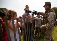 EAST MEADOW, N.Y. - A Marine teaches a child about a rifle after a helicopter raid demonstration at Eisenhower Park May 28. The demonstration was held by Marines with the 24th Marine Expeditionary Unit as part of Fleet Week New York 2011. More than 3,000 Marines, sailors and Coast Guardsmen are participating in community events and demonstrations as part of Fleet Week. This is the 27th year New York has hosted the sea services for Fleet Week. (Official Marine Corps photo by Sgt. Randall A. Clinton / RELEASED)