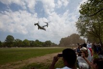 EAST MEADOW, N.Y. - Spectators wave and take photos of the MV-22 Osprey leaving after a helicopter raid demonstration at Eisenhower Park during Fleet Week New York 2011, May 28. The demonstration was held by Marines with the 24th Marine Expeditionary Unit as part of Fleet Week New York 2011. He is one of more than 3,000 Marines, sailors and Coast Guardsmen in the area participating in community events and demonstrations as part of Fleet Week. This is the 27th year New York has hosted the sea services for Fleet Week. (Official Marine Corps photo by Sgt. Randall A. Clinton / RELEASED)