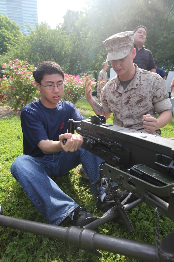 Cpl. Robert Neubauer, a machine gunner with 2nd Battalion, 9th Marine Regiment, 24th Marine Expeditionary Unit, showcases a 50. Caliber Machine Gun to a New Yorker at Battery Park May 28. Various units from II Marine Expeditionary Force and Marines Forces Reserve have organized under the 24th Marine Expeditionary Unit to form the Special Purpose Marine Air Ground Task Force - New York. The Marines embarked on the Navy’s Amphibious Assault Ships, the USS Iwo Jima (LHD -7) and USS New York (LPD-21) to take part in Fleet Week New York 2011 from May 25 to June 1. The Marines will showcase the capabilities of the MAGTF, and also honor those who have served by participating in various events during the Memorial Day weekend.