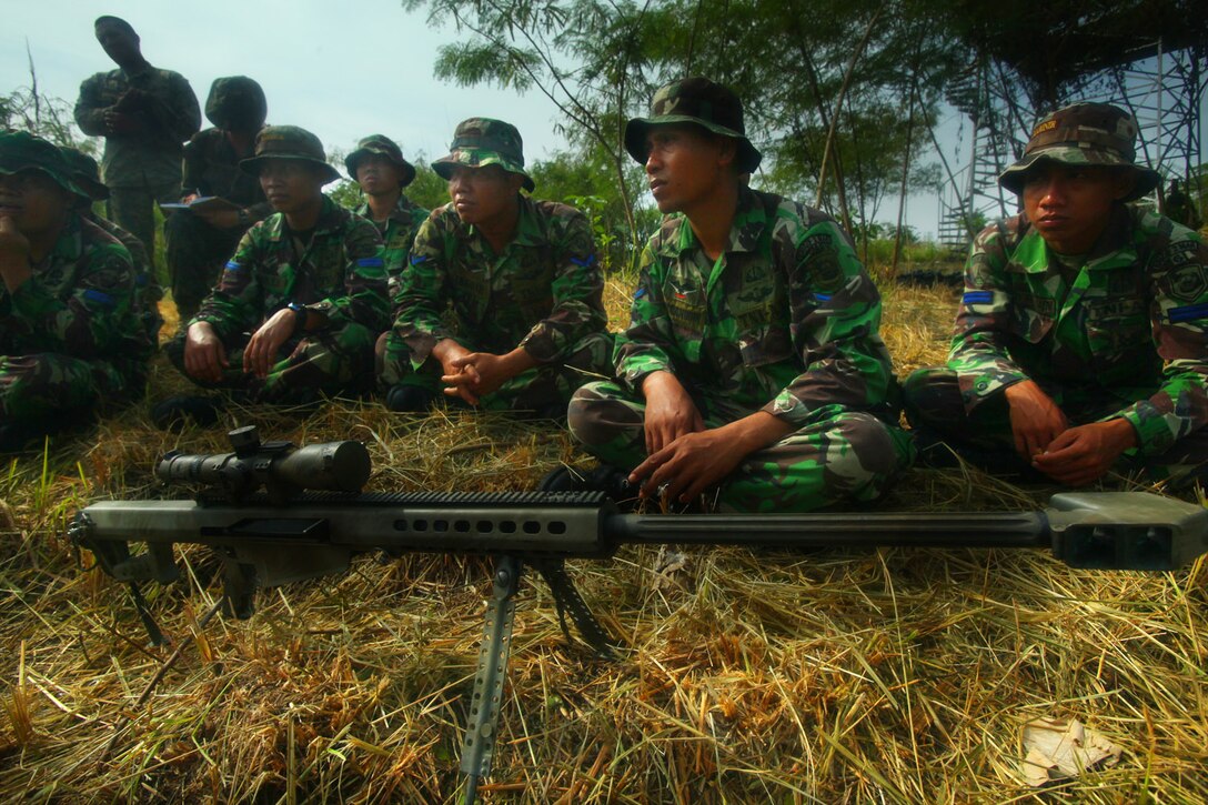 Indonesian Marines are familiarized with the M-82 Special Application Scoped Rifle during sniper training with U.S. Marines from Landing Force Company May 29. After instruction, the Indonesian Marines fired the rifle.  Landing Force Company is participating in Cooperation Afloat Readiness and Training (CARAT) 2011. CARAT is an annual series of bilateral exercises held between the U.S. and Southeast Asian nations with the goals of enhancing regional cooperation, promoting mutual trust and understanding, and increasing operational readiness. While in Indonesia, the service members from both nations train together on martial arts, military operations on urban terrain, jungle warfare, combat marksmanship and combat lifesaving.