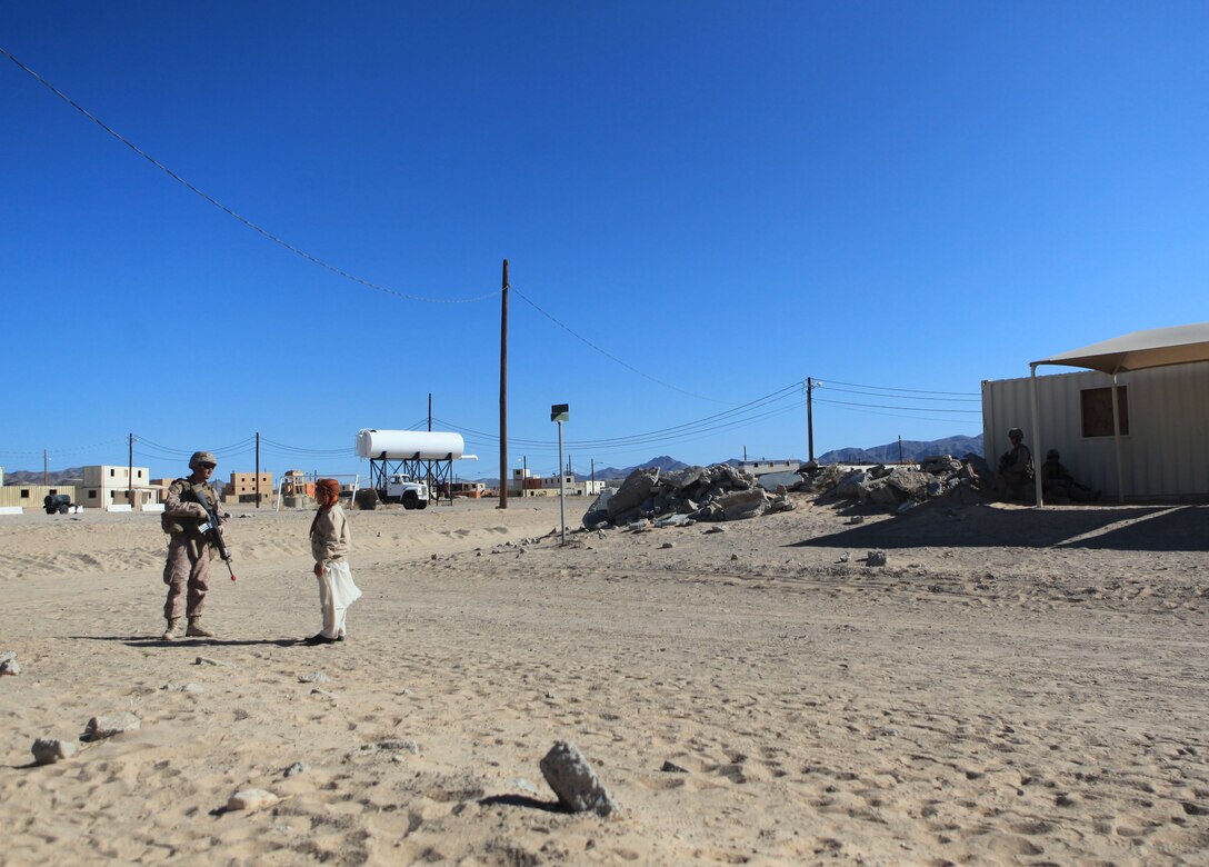 A Marine with Company B, 1st Battalion, 6th Marine Regiment, 2nd Marine Division, speaks with a role player during a cordon and search exercise, at the military operations in urban terrain facility, aboard Marine Corps Base 29 Palms, Calif., May 30, 2011. The exercise included Afghan nationals who served as role-players and provided the Marines with a realistic training experience in preparation for their upcoming deployment to Afghanistan.