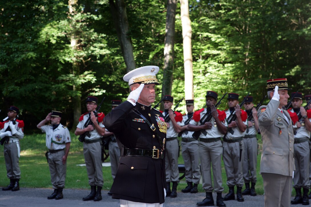 The 35th Commandant of the Marine Corps General James F. Amos and French Commander of Land Forces Lt. Gen. Herve Charpentier salute the Iron Mike monument atop a hill in the heart of the Belleau Wood forest during a private Memorial Day ceremony in front of a formation of Marines and French soldiers. Following World War I, the French government renamed the Belleau Wood forest “Wood of the Marine Brigade." (Marine Corps photo by Master Sgt. Grady T. Fontana)