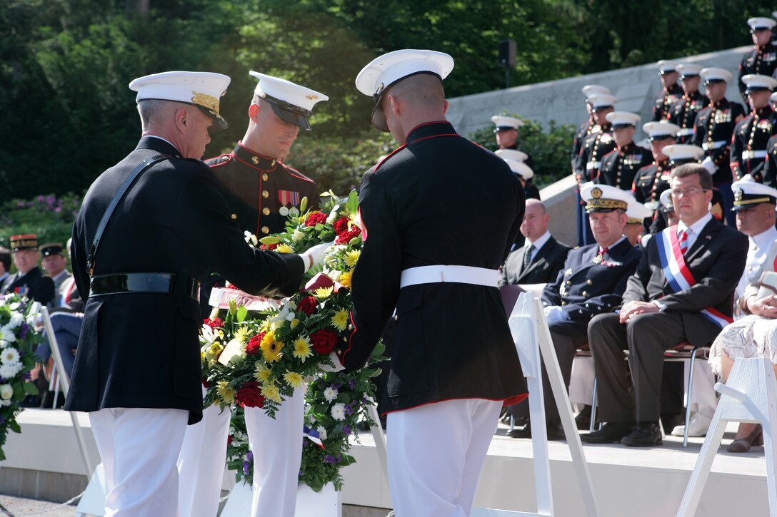The 35th Commandant of the Marine Corps General James F. Amos lays a wreath at the foot of the steps that lead to the chapel at the Aisne-Marne American Cemetery in front of dignitaries and a formation of Marines from 5th and 6th Marine Regiments during a Memorial Day ceremony here. At the cemetery, there are 2,039 known buried and 250 unknown. In the chapel, there are 1,060 names inscribed on the walls to commemorate the missing—all from the Battle of Belleau Wood. (Marine Corps photo by Master Sgt. Grady T. Fontana)