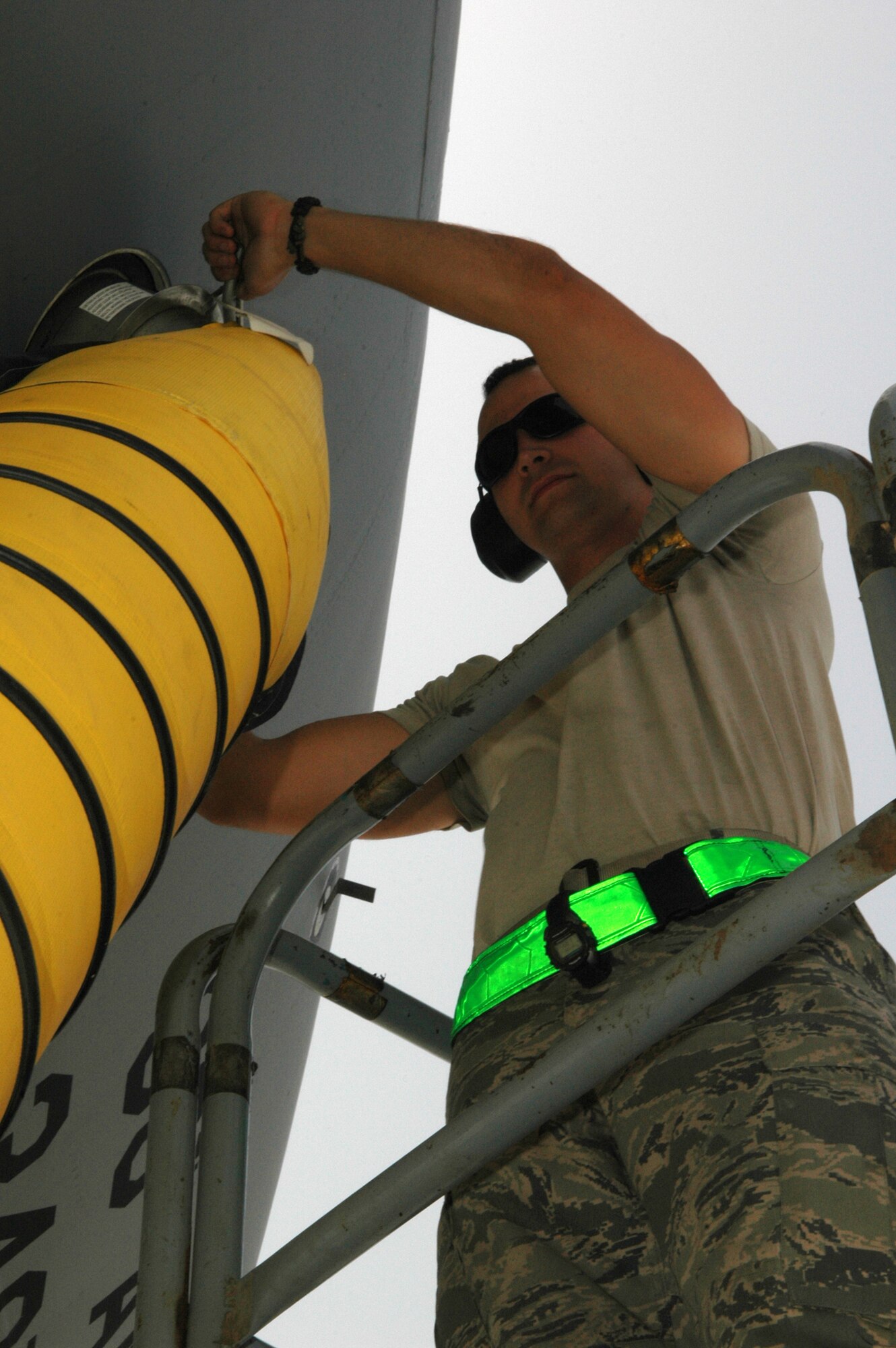 Airman 1st Class Matthew Haynes, 380th Expeditionary Aircraft Maintenance Squadron crew chief for the KC-10 Extender, seals an air cart hose to the side of the aircraft in Southwest Asia. One hour prior to the air crew's arrival, the air carts help prevent the tanker's internal electrical components from overheating during extreme temperatures in the Area of Responsibility. Airman Haynes is deployed from 605th AMXS, McGuire AFB, N.J. (U.S. Air Force photo by Master Sgt. Julie Briden-Garcia)
