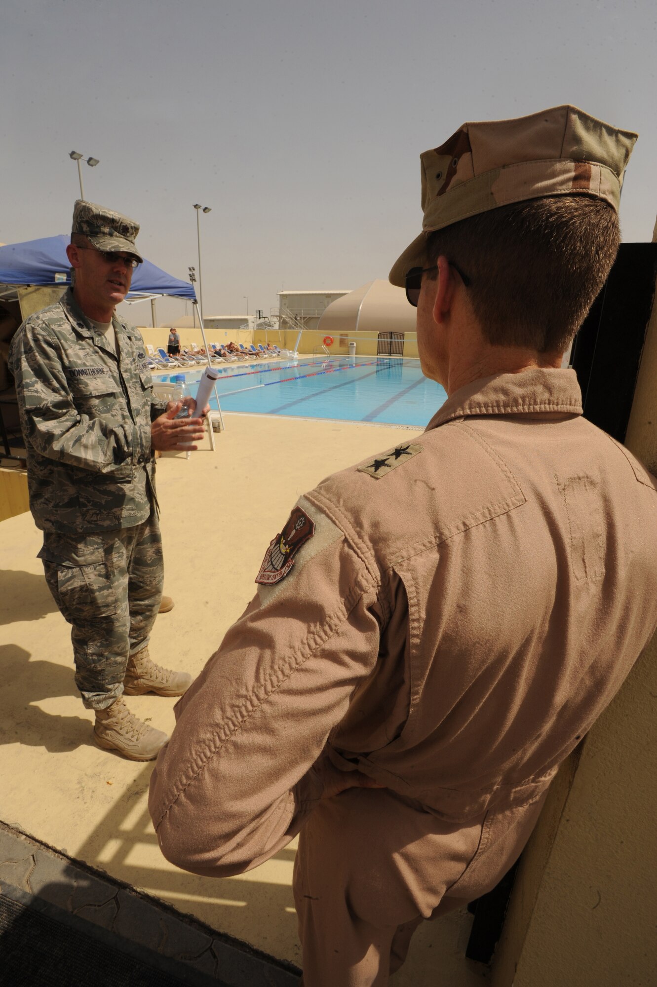 Lt. Col. Mark Donnithorne, 380th Expeditionary Civil Engineer Squadron commander, briefs Maj. Gen. Mark Graper, Assistant Deputy Commander, U.S. Air Forces Central Command, on some of the various projects ECES is responsible for while touring the base and receiving insight on the 380th Air Expeditionary Wing mission. General Graper met with various squadron and group leaders during his visit to the 380th Air Expeditionary Wing May 12, 2011, in Southwest Asia. (U.S. Air Force photo by Senior Airman Maynelinne De La Cruz)