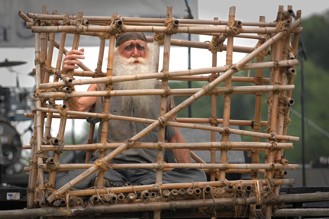 Rolling Thunder participant Gerald McCullar portrays a prisoner of war in a Vietnam War-era "Tiger Cage" at the 2011 Rolling Thunder Memorial Day weekend ceremony on the National Mall, May 29, 2011. Defense Secretary Robert M. Gates and Navy Adm. Mike Mullen, chairman of the Joint Chiefs of Staff, spoke at the annual event that draws thousands of motorcyclists to the capitol in an effort to raise awareness for troop and veteran issues. 