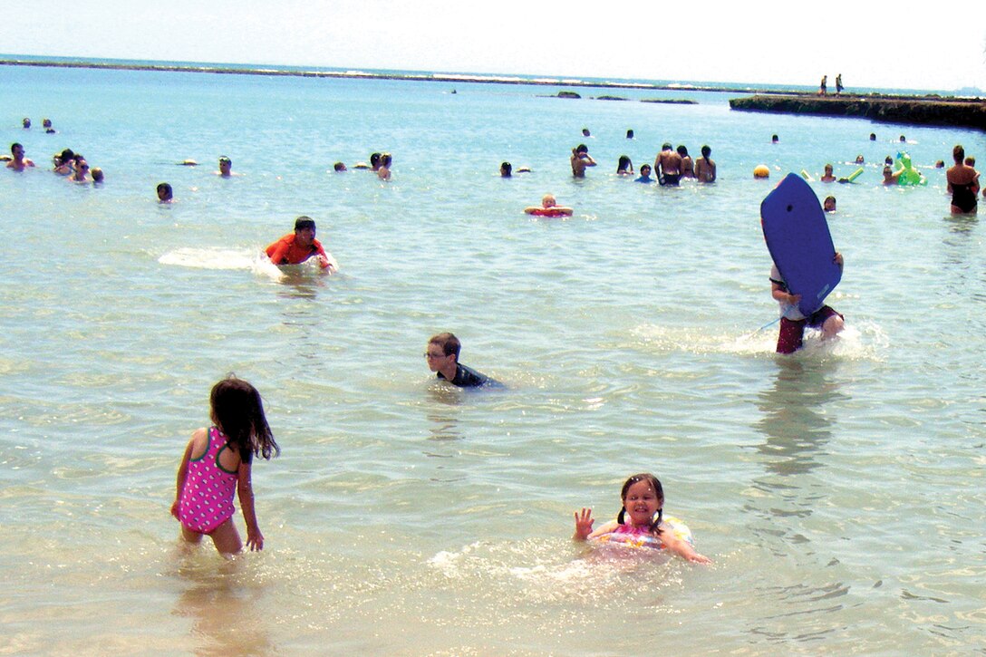 Service members, their families and members of the local community swim and play at Kadena Marina May 30. The Marine Corps Bases Japan Installation Safety Office personnel say the best way to prevent a casualty at the sea this summer is to avoid risky behavior.