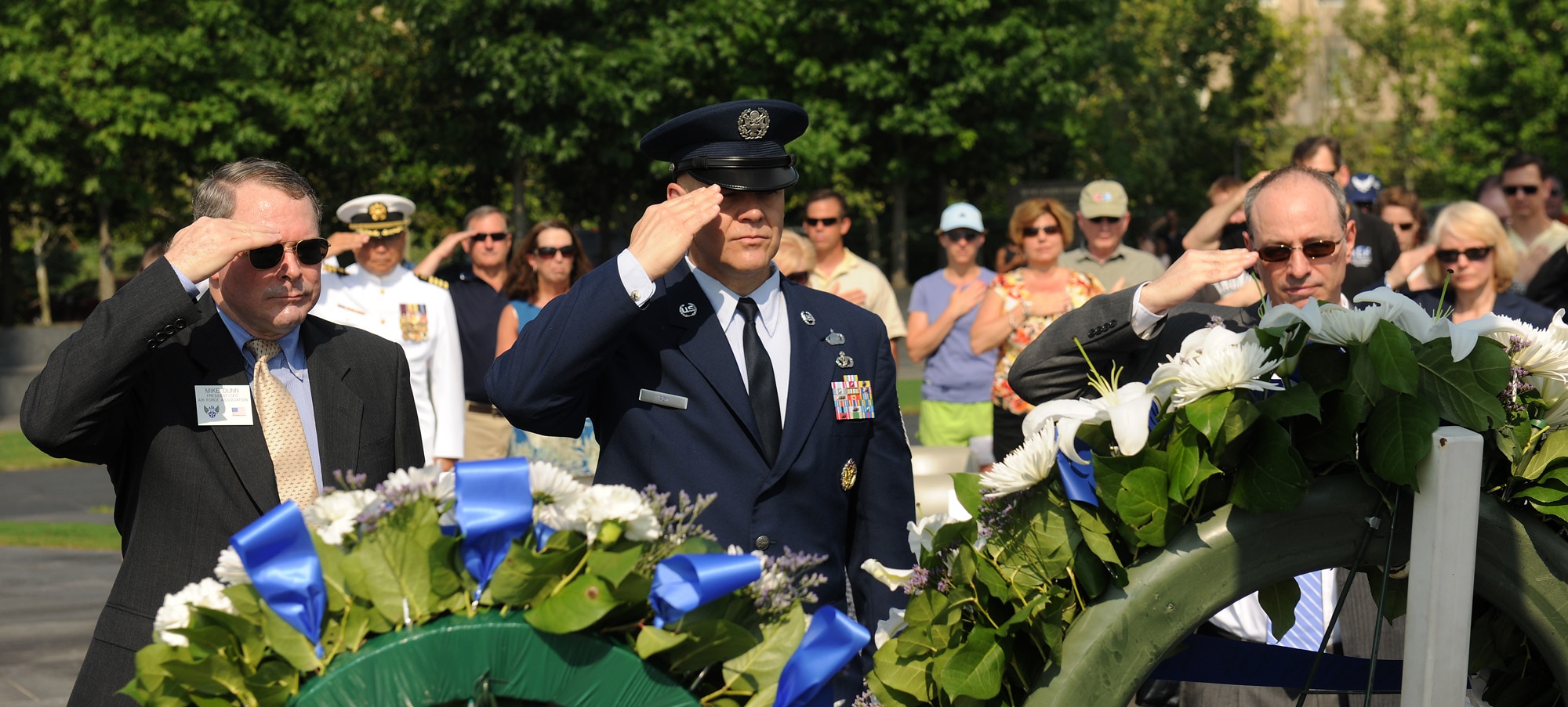 Mike Dunn (from left), president and chief executive officer of the Air Force Association and the Air Force Memorial Foundation; Chief Master Sgt. of the Air Force James Roy; and Dan Derrow, deputy chief executive officer of the Air Force Sergeants' Association, salute during a Memorial Day ceremony May 30, 2011, honoring those who gave their lives in service in the last year.  The ceremony was at the Air Force Memorial in Arlington, Va.  During the ceremony, Chief Roy read the names of each of the Airmen who died in combat in the past year.  (U.S. Air Force photo/Scott M. Ash)
