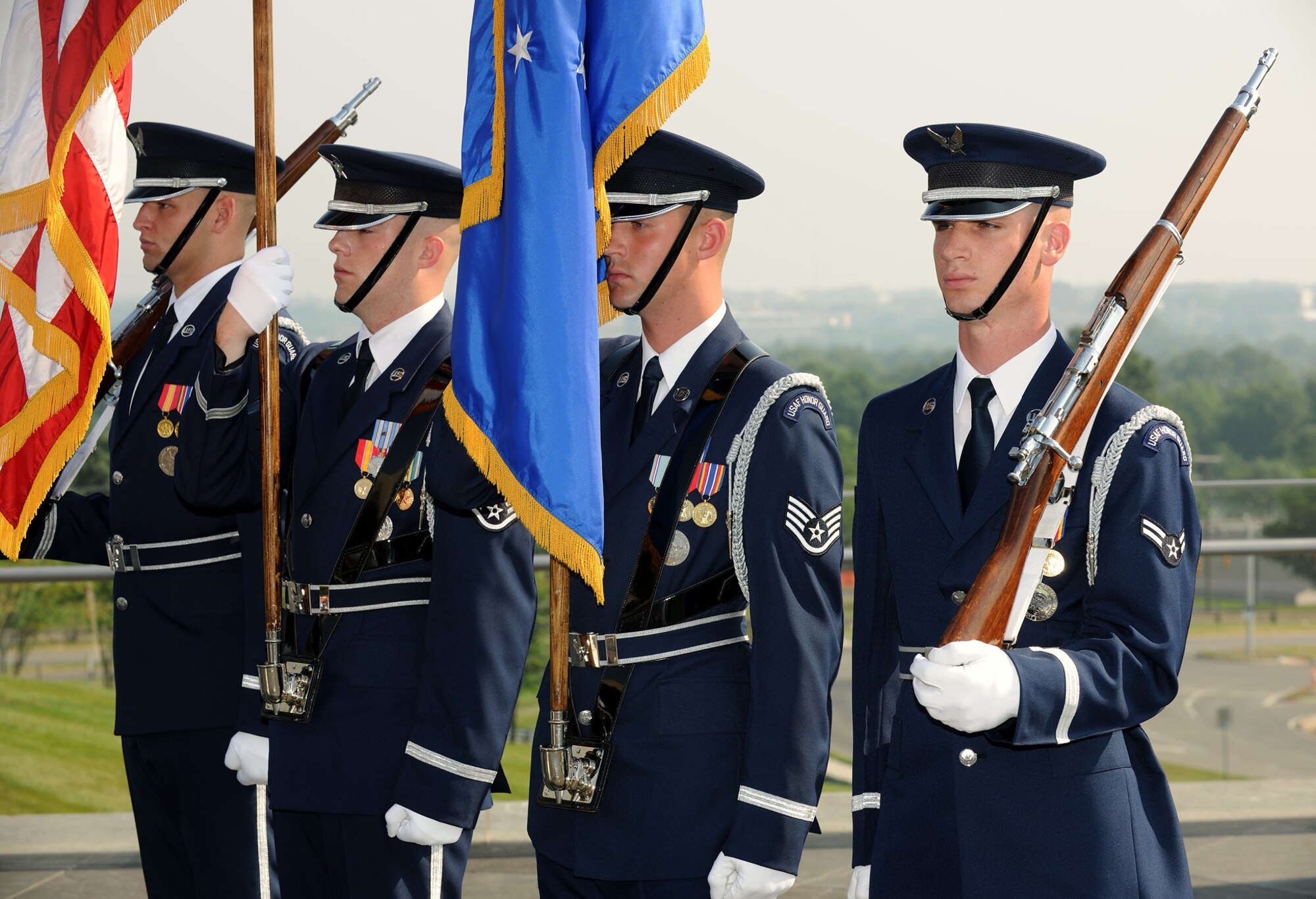The U.S. Air Force Honor Guard's color team stands at attention at a Memorial Day ceremony May 30, 2011, honoring those who gave their lives in service in the last year.  The ceremony was at the Air Force Memorial in Arlington, Va., and hosted by the Air Force Association and the Air Force Sergeants' Association.  During the ceremony, Chief Master Sgt. of the Air Force James Roy read the names of each of the Airmen who died in combat.  (U.S. Air Force photo/Scott M. Ash)