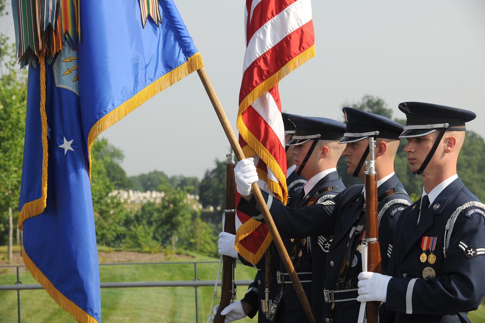 The U.S. Air Force Honor Guard's color team stands at attention during the playing of the national anthem at a Memorial Day ceremony May 30, 2011, honoring Airmen who gave their lives in the past year.  The ceremony was at the Air Force Memorial in Arlington, Va., and hosted by the Air Force Association and the Air Force Sergeants' Association.  Chief Master Sgt. of the Air Force James Roy read the names of each of Airmen who were lost in combat during the ceremony.  (U.S. Air Force photo/Scott M. Ash)