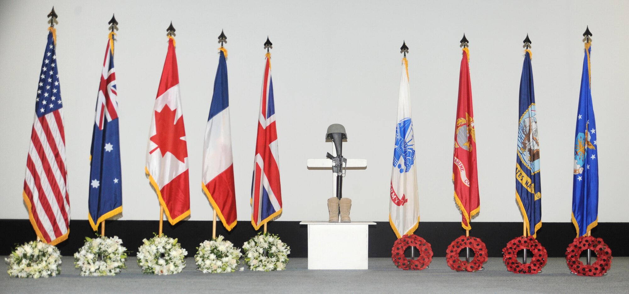 A memorial of wreaths lies after a Memorial Day Ceremony at an undisclosed location in Southwest Asia, May 30. Military personnel from the U.K., Australia, Canada, France and the United States took time from their duties in support of current military operations to commemorate the sacrifice of their fellow military personnel from past and current conflicts. (U.S. Air Force photo/Staff Sgt. Liliana Moreno)                                 