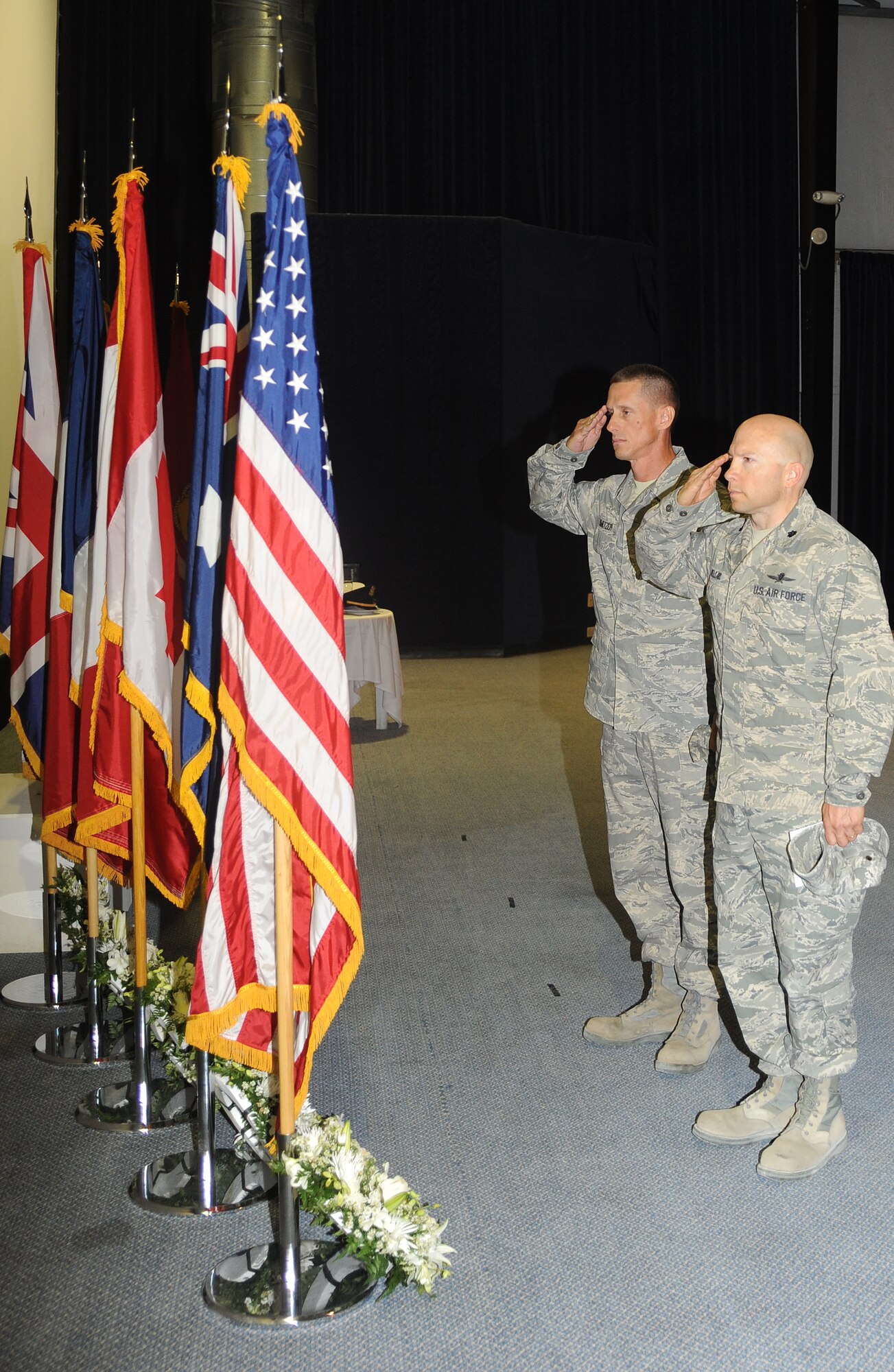 Senior Master Sgt. Patrick Smetzer and Lt. Col. Douglas Mellars, 379th Expeditionary Communications Squadron, pay respect to the fallen during a Memorial Day Ceremony at an undisclosed location in Southwest Asia, May 30. Memorial Day is a day of remembrance for those who have died in our nation's service. (U.S. Air Force photo/Staff Sgt. Liliana Moreno)      