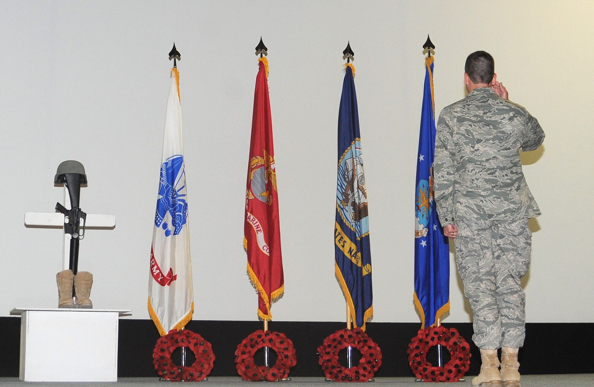 Col. Paul Tibbets IV, 379th Air Expeditionary Wing vice commander, salutes the Air Force flag after placing a wreath in remembrance of fallen Airmen during a Memorial Day Ceremony at an undisclosed location in Southwest Asia, May 30. Each wreath represents a branch of service in the Department of Defense and honors those who have died in service to the United States. (U.S. Air Force photo/Staff Sgt. Liliana Moreno)              