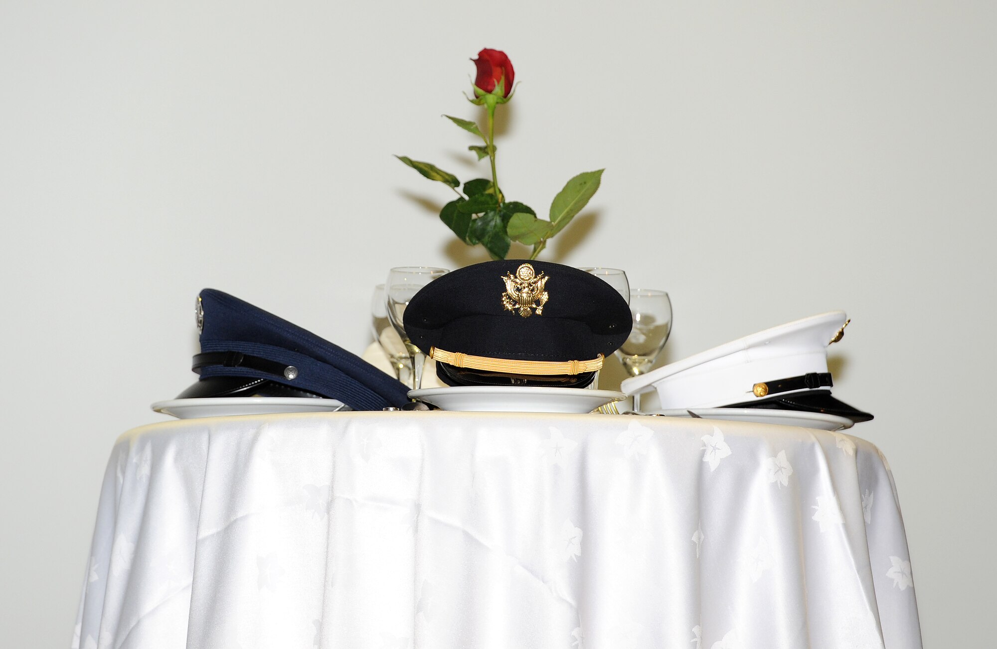 During a Memorial Day Ceremony at an undisclosed location in Southwest Asia, May 30, a POW/MIA table stands in front of the stage. The table serves as a remembrance and tribute to veterans killed or missing in action, along with those held as prisoners of war. (U.S. Air Force photo/Staff Sgt. Liliana Moreno)          