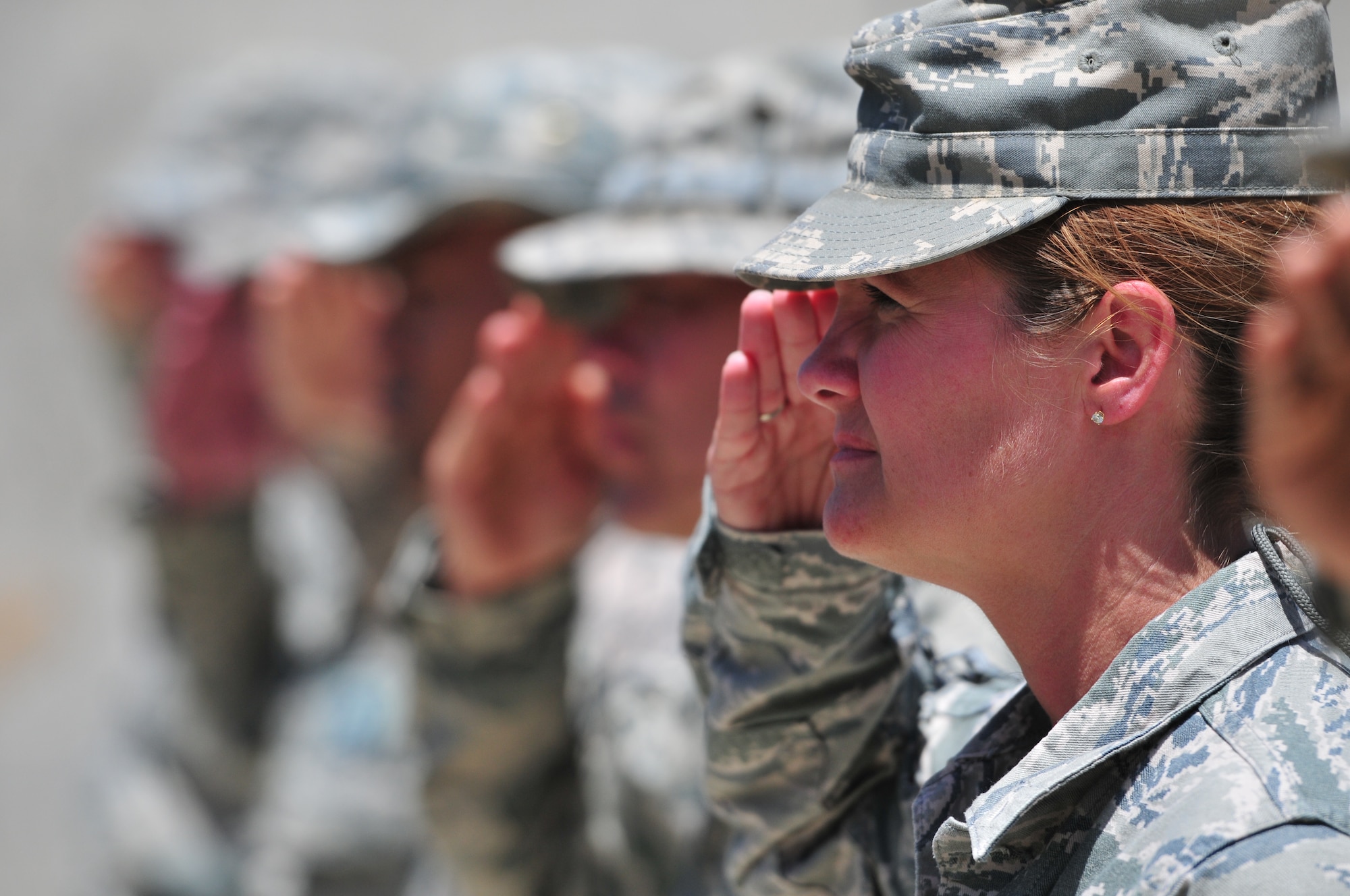 KABUL, Afghanistan - Master Sgt. Shawna Meadows, 438th Air Expeditionary Wing, salutes the flag during a ceremony to commemorate Memorial Day.  The day serves to honor military members currently serving and those that have died while in military service.  Many Americans observe Memorial day by visiting cemeteries and memorials with the U.S. flag usually flying at half staff.  (US Air Force Photo by Tech. Sgt. Brian E. Christiansen)