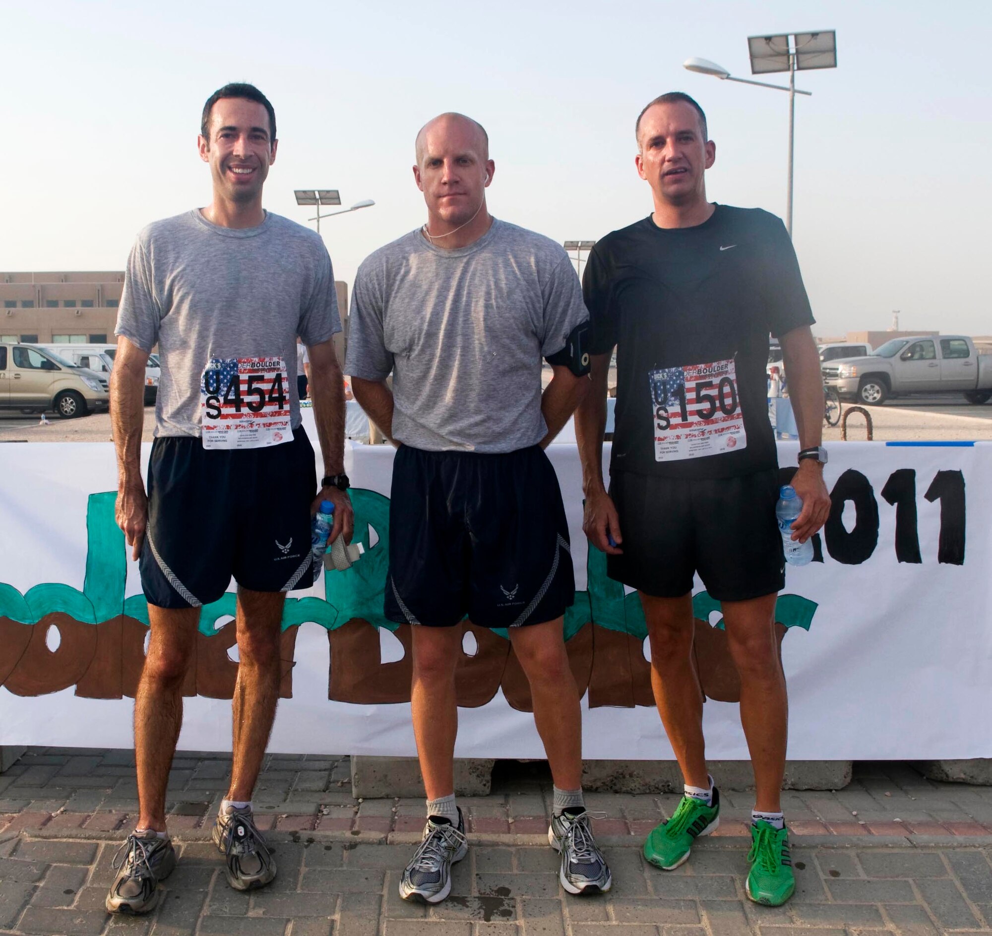 Capt. David Nierenberg, Airman 1st Class Christopher Heaser, and Lt. Col. Chris Leeuw pose for a photo after placing as the top three finishers in the Bolder Boulder 10K run May 30 while deployed to Southwest Asia. (U.S. Air Force photo/Staff Sgt. Anthony Graham)