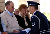 Tech. Sgt. Michael Lewis (Right), 28th Bomb Wing Honor Guard NCO in charge, hands a folded U.S. flag to Edward Kooper, brother to 1st Lt. Clark Kooper, a U.S. Army Air Force pilot shot down during World War II, at the Nebraska Veterans Cemetery, Alliance, Neb., May 27, 2011. Lieutenant Kooper was shot down in the Philippines while flying a P-51 Mustang, March 14, 1945. (U.S. Air Force photo by Senior Airman Jarad A. Denton)