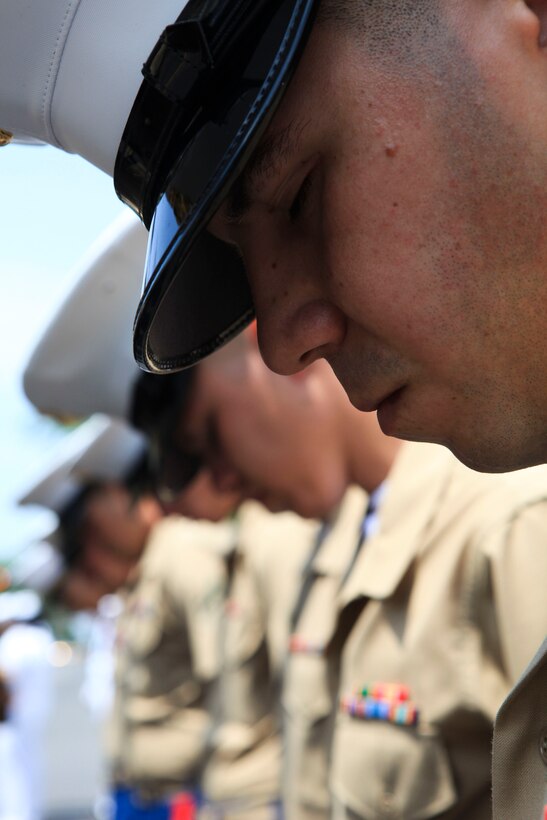 Marines from the 24th Marine Expeditionary Unit drop their heads in prayer before marching in a Memorial Day parade at Glendale, New York, May 30, 2011. Various units from II Marine Expeditionary Force and Marines Forces Reserve have organized under the 24th Marine Expeditionary Unit to form the Special Purpose Marine Air Ground Task Force - New York. The Marines are embarking on the Navy’s Amphibious Assault Ships, the USS Iwo Jima (LHD -7) and USS New York (LPD-21) to take part in New York City's Fleet Week from May 25 to June 1, 2011. There, the Marines will showcase the capabilities of the MAGTF, and also honor those who have served by participating in a various of events during the Memorial Day weekend.