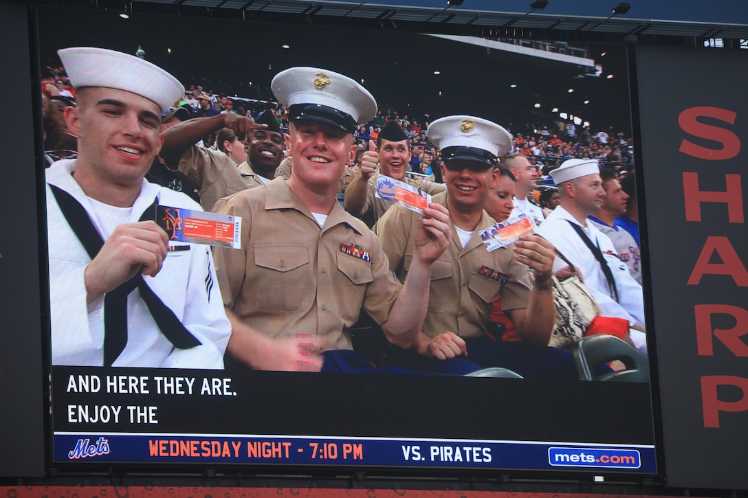 Marines and Sailors show of their upgraded tickets at a New York Mets game on the big screen, May 30, 2011. Various units from II Marine Expeditionary Force and Marines Forces Reserve have organized under the 24th Marine Expeditionary Unit to form the Special Purpose Marine Air Ground Task Force - New York. The Marines are embarking on the Navy’s Amphibious Assault Ships, the USS Iwo Jima (LHD -7) and USS New York (LPD-21) to take part in New York City's Fleet Week from May 25 to June 1, 2011. There, the Marines will showcase the capabilities of the MAGTF, and also honor those who have served by participating in a various of events during the Memorial Day weekend.