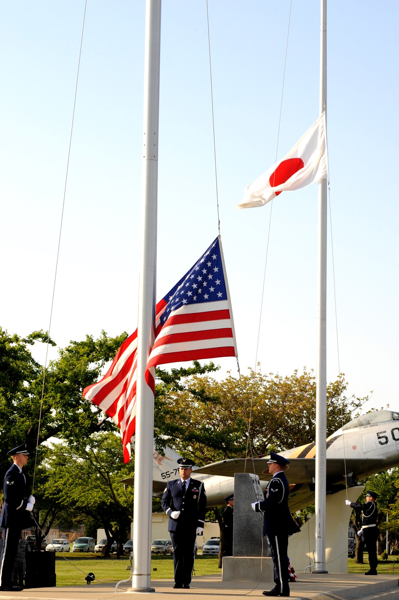 MISAWA AIR BASE, Japan -- The Misawa Air Base Honor Guard and the Japan Air Self-Defense Force lower their respective flags during the base's Memorial Day ceremony May 26.  The ceremony, to honor all fallen service members, had more than 300 military members, retirees and dependents participating.  (U.S. Air Force Photo/Staff Sgt. April Quintanilla)