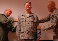 A 919th Special Operations Wing member has his new stripes tacked on during an earlier promotion ceremony at Duke Field.  Twenty two of the wing's enlisted Airmen will likewise have their new rank applied with promotions in June.  (U.S. Air Force photo/Tech. Sgt. Samuel King Jr.)