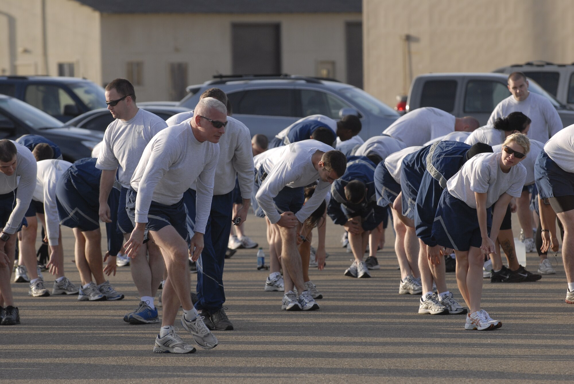 VANDENBERG AIR FORCE BASE, Calif. -- Team V members stretch during the Wing Run at the parade grounds here Tuesday, May 31, 2011.  The 30th WS led the Wing Run before the squadron inactivates on Friday, June 3.  (U.S. Air Force photo/Staff Sgt. Andrew Satran) 

 