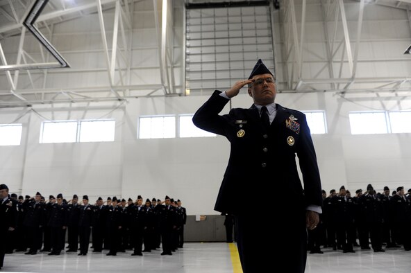 MINOT AIR FORCE BASE, N.D. -- Col. Julian Tolbert, 5th Bomb Wing vice commander, leads the troop formation in a ceremonial salute to Col. James Dawkins May 31. Colonel Dawkins is the 51st commander of the 5th Bomb Wing “Warbirds.” The change-of-command ceremony is one of the Air Force’s time-honored traditions. (U.S. Air Force photo by Airman 1st Class Aaron-Forrest Wainwright) 