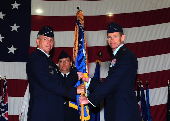 MINOT AIR FORCE BASE, N.D. -- Maj. Gen. Floyd Carpenter, Eighth Air Force commander, passes the 5th Bomb Wing guidon to Col. James Dawkins after he assumed command May 31. Colonel Dawkins is the 51st commander of the 5th Bomb Wing “Warbirds.” The change-of-command ceremony is one of the Air Force’s time-honored traditions. (U.S. Air Force photo by Senior Airman Michael J. Veloz) 