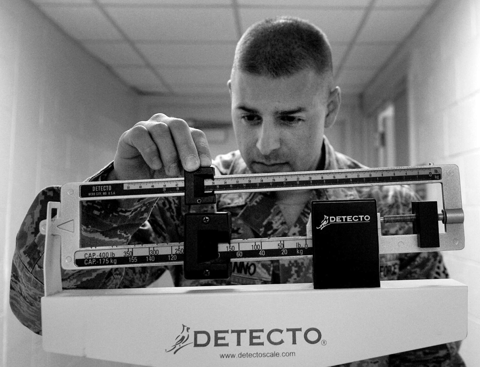 Tech. Sgt. Anthony Bonanno measures his weight May 31, 2011, Eielson Air Force Base, Alaska. The push for a lean and mean Air Force has many Airmen looking for workouts and diets to run faster, push harder and lose inches off their waist. Military members looking for assistance can contact the Health and Wellness Center to talk to a dietician. Sergeant Bonanno is the 354th Force Support Squadron NCO in charge of the fitness center. (U.S. Air Force photo/Airman 1st Class Laura Goodgame)