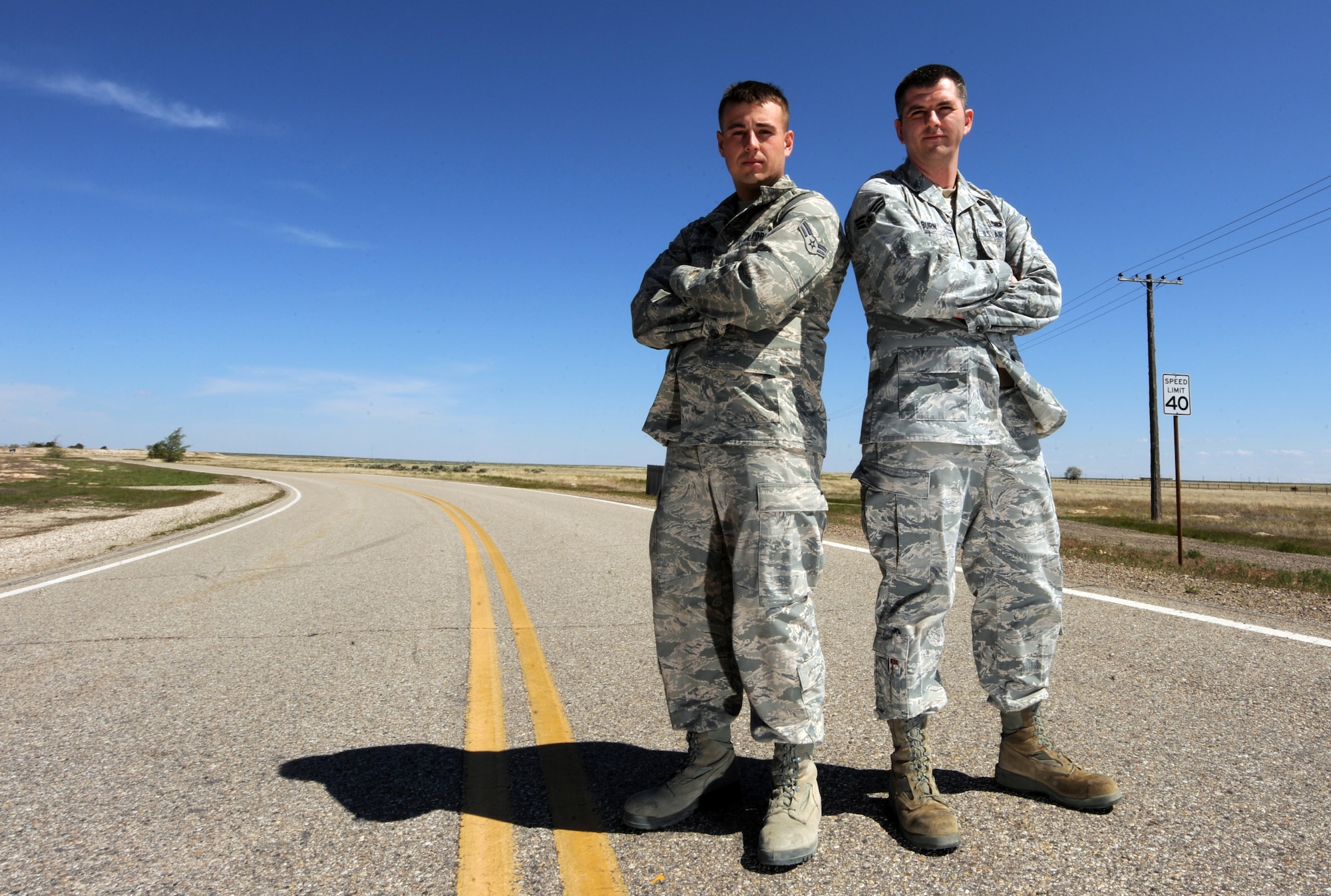 MOUNTAIN HOME AIR FORCE BASE, Idaho – Airman 1st Class Brandon Kilburg and Senior Airman Justin Ogburn, 366th Equipment Maintenance Squadron precision guided munitions crew members, helped an injured woman escape from her vehicle after it rolled three times and landed upside-down on highway I-84, May 22. Both Airmen said the Air Force training they have received helped them provide aide to the hurt woman. (U.S. Air Force photo by Senior Airman Debbie Lockhart)