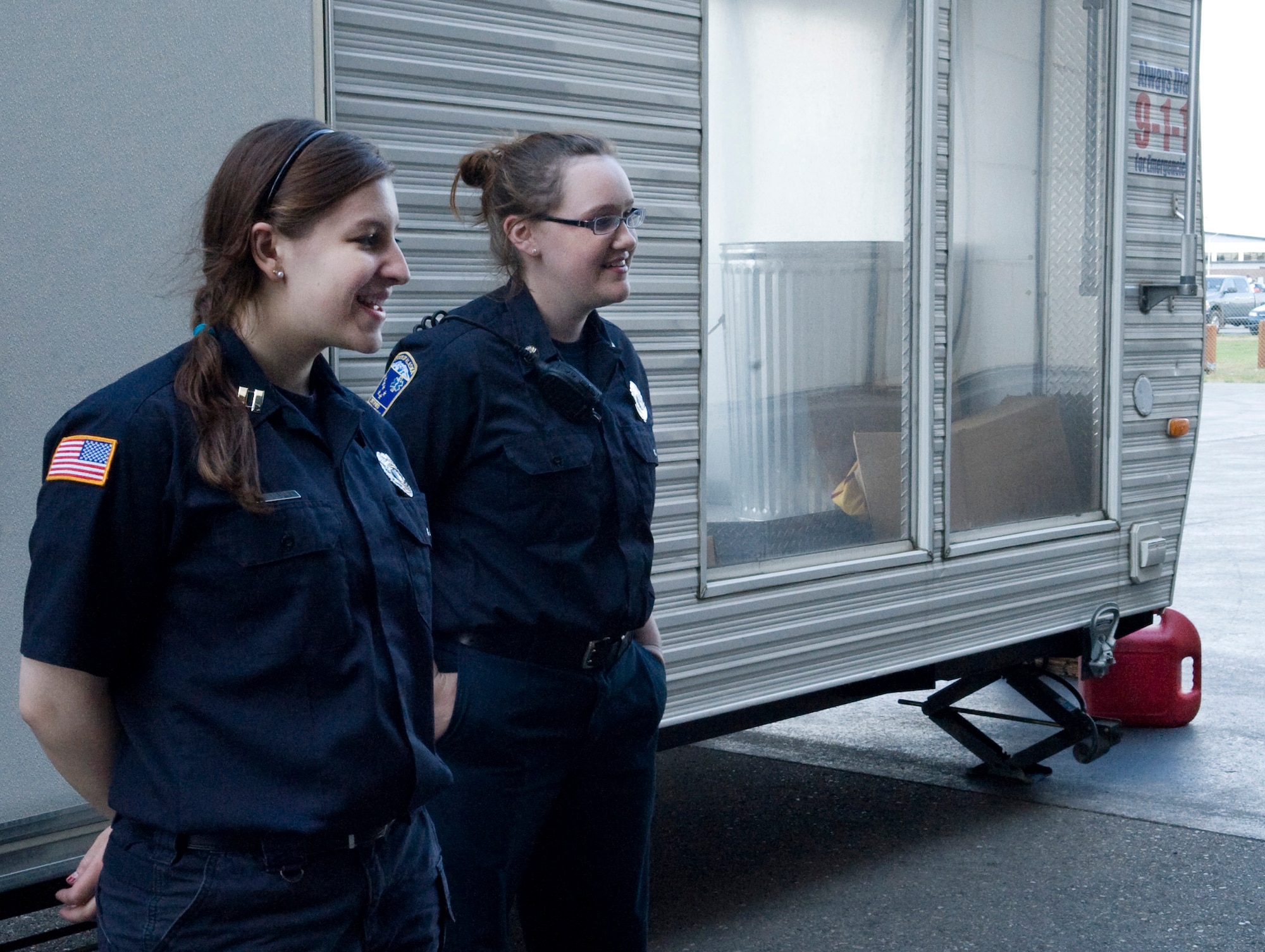 Shelby Perkins and Kathryne Stalker teach Airmen and their families what to do if their house catches on fire during the annual summer safety fair May 26, 2011, Eielson Air Force Base, Alaska. Eielson personnel were given the opportunity to navigate a simulated burning house to get a sense of what it takes to escape alive. Miss Perkins and Stalker are volunteer fire fighters with the North Star Volunteer fire department. (U.S. Air Force photo/Airman 1st Class Laura Goodgame) 