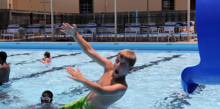 Adam Smith, 8, shoots out of a slide during open swim time at the North Pool on Barksdale Air Force Base, La., May 31. For more information on swim lessons, pool parties, lap swim and open swim times, call 456-3482 or 456-3389. Adam is the grandson of retired Air Force member Bill Ringler. (U.S. Air Force photo/Senior Airman La'Shanette V. Garrett) (RELEASED)
