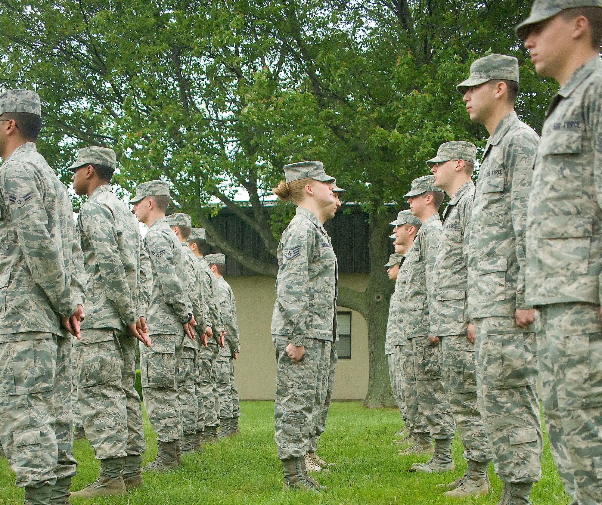 Staff Sgt. Jessica Nienhueser (center) and Staff Sgt. Ali Bueshi, 373rd Training Squadron military training leaders, inspect Det. 3 Airmen's appearances May 24, 2011, at Dover Air Force Base, Del. The MTLs assure that Airmen in technical training retain the standards and discipline taught to them during basic military training. (U.S. Air Force photo/Adrian Rowan)