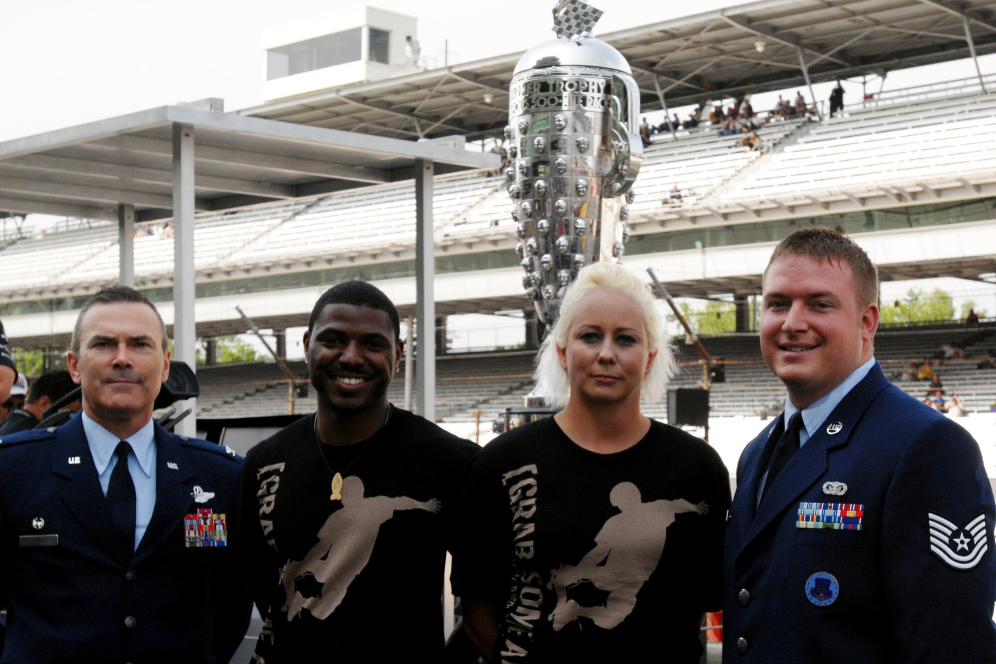 GRISSOM AIR RESERVE BASE, Ind. -- Col. William T. "Tim" Cahoon, left, 434th Air Refueling Wing commander, stands new recruits Patterson Burks, and Sheri Ashcraft, and Tech. Sgt. Shawn Emmerling, recruiter, following a mass enlistment at the Indianapolis Motor Speedway May 22. The recruits were part of a group sworn in by Brig. Gen. Steward Goodwin, assistant adjutant general for the Indiana Air National Guard. (U.S. Air Force photo/Maj. Kelly Howard)