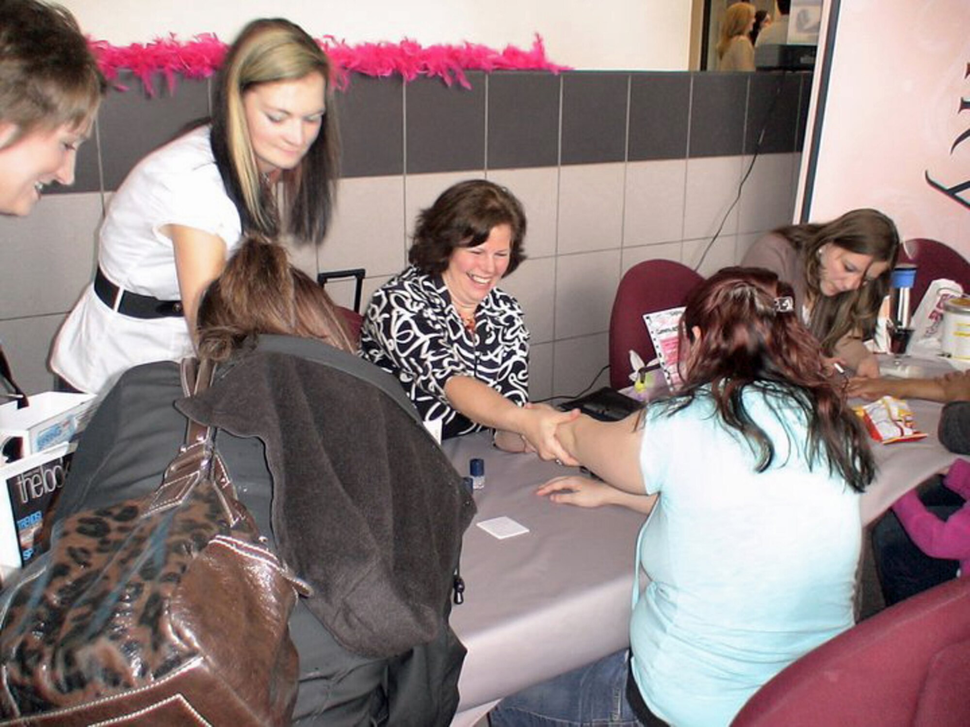 PETERSON AIR FORCE BASE, Colo. – It was an afternoon of being pampered for Peterson Air Force Base spouses at the first Airman and Family Readiness Center’s Military Spouse Appreciation Day May 24, 2011, at the Building 350 atrium. More than 200 spouses were treated to makeovers, hand massages, finger nail treatment and other beauty tips. They also received educational information and had an opportunity to talk with Family Advocacy about stress and deployments. About 100 children had their faces painted and played other games with volunteers from the Youth Center and the Child Development Centers and all were treated to lunch and gifts provided by Army and Air Force Exchange Service, the Defense Commissary Agency and the Peterson Club. Organizers from the Airman and Family Readiness Center called the event a huge success and said they plan to host one again next year. (Photo courtesy of the A&FRC)