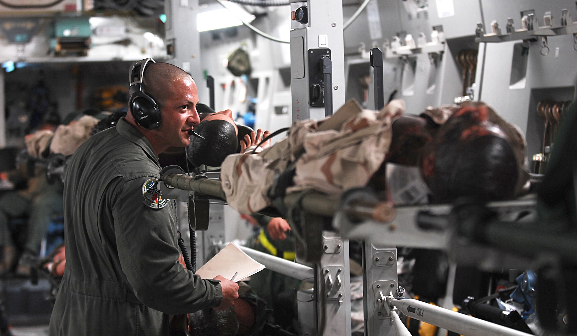 U.S. Air Force Staff Sgt. Martin Duran, an aeromedical technician with the 446th Aeromedical Evacuation Squadron, checks the status of a simulated casualty during an aeromedical evacuation mission aboard a C-17 Globemaster III aircraft at Schoonover Field, Fort Hunter Liggett, Calif., May 21, 2011, in support of Global Medic 2011 and Warrior 91 11-01. Global Medic is a joint field training exercise for theater aeromedical evacuation system and ground medical components designed to replicate all aspects of combat medical service support. (U.S. Air Force photo by Staff Sgt. Donald R. Allen/Released)