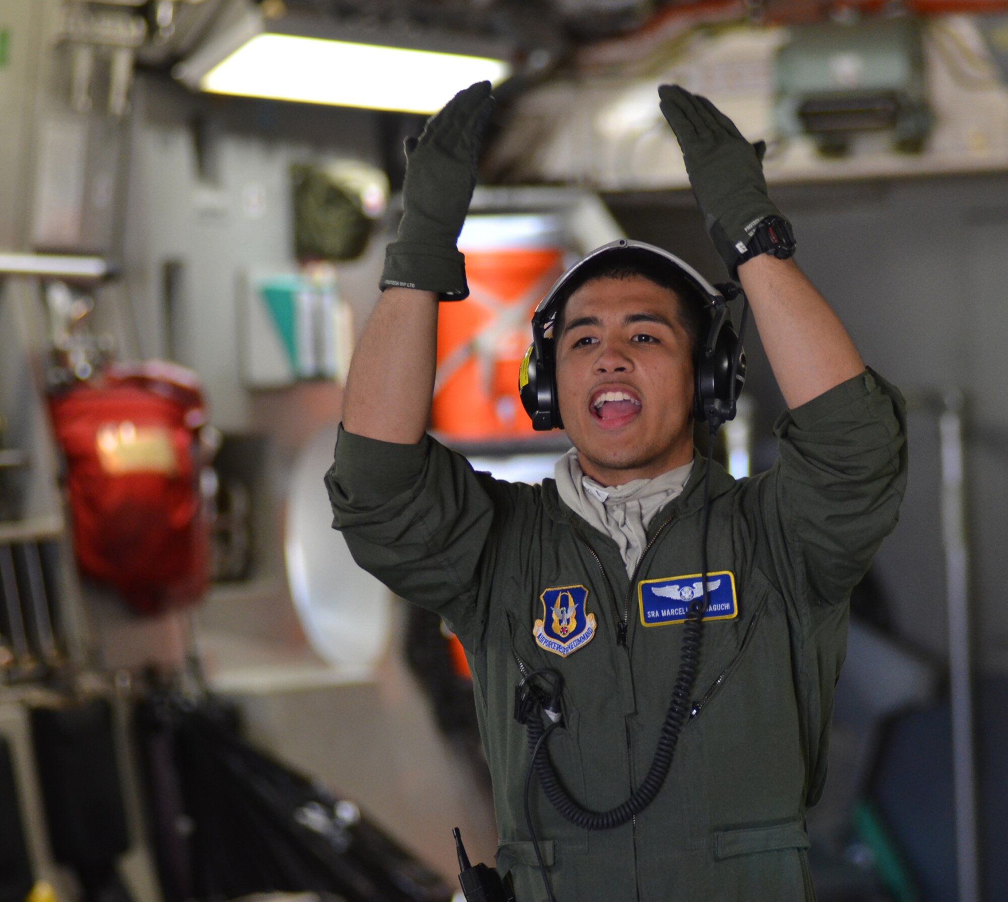U.S. Air Force Senior Airman Marcello Yamaguchi, a flight medic with the 446th Aeromedical Evacuation Squadron, Joint Base Lewis-McChord, Wash., directs Army and Air Force medical personnel loading a simulated casualty on a C-17 Globemaster aircraft at Schoonover Airfield, at Fort Hunter Liggett, Calif., May 20, 2011, in support of Global Medic 2011 and Warrior 91 11-01. Global Medic is a joint field training exercise for theater aeromedical evacuation system and ground medical components designed to replicate all aspects of combat medical service support. Warrior Exercise gives participating units an opportunity to rehearse military maneuvers and tactics such as security, convoy operations and quick reaction drills during simulated enemy attacks. (U.S. Air Force photo by Senior Airman Raymond A. Estes/Released)