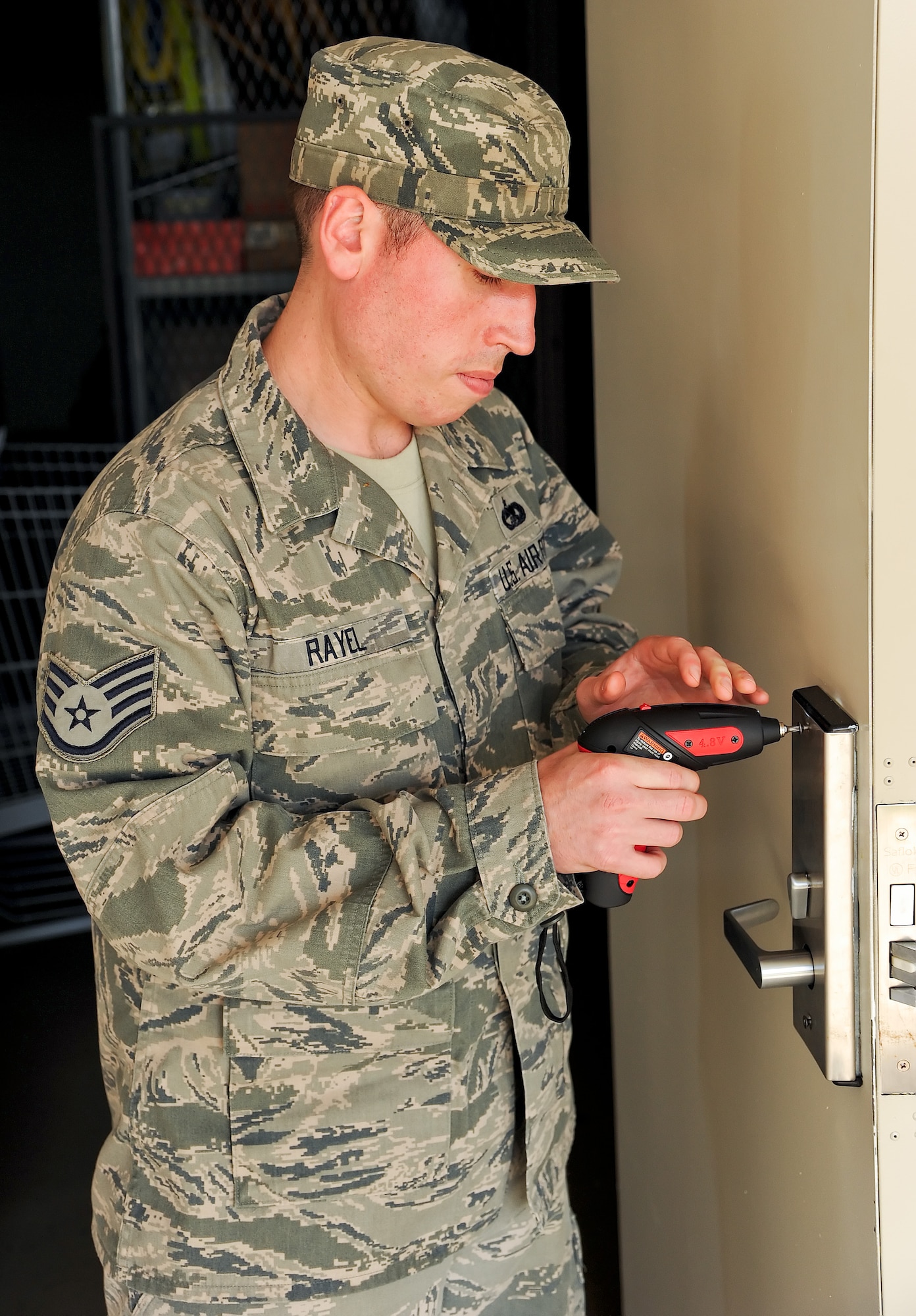 Staff Sgt. Patrick Rayel, 436th Civil Engineer Squadron Airmen dormitory leader, performs maintenance on an electronic locking system May 31, 2011, at the Dorms 4 Airmen at Dover Air Force Base, Del. Sergeant Rayel is one of the ADLs who keep the dormitories running smoothly. (U.S. Air Force photo by Airman 1st Class Jacob Morgan)
