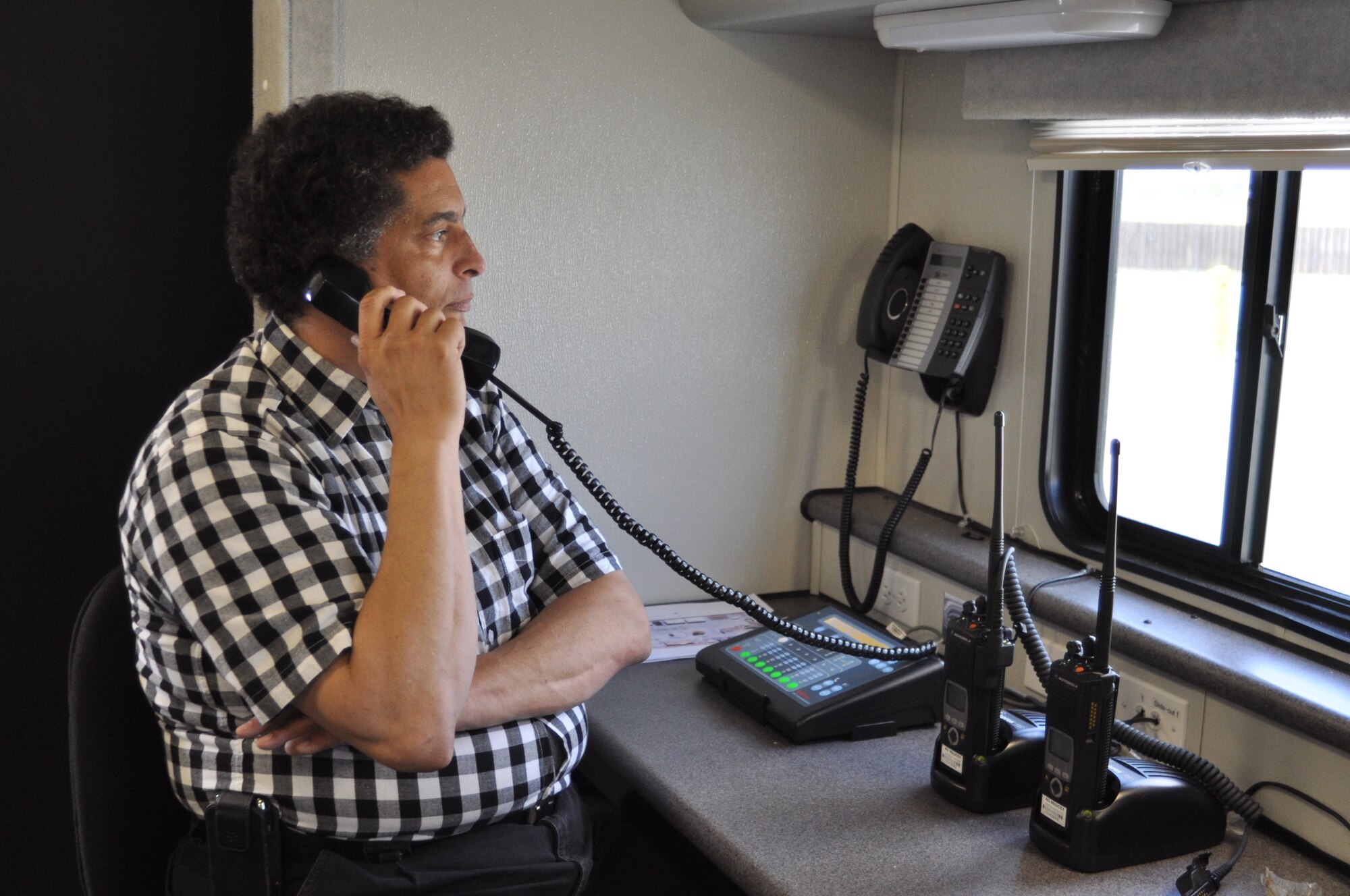 Barry Cannon, 452nd Communications Squadron, conducts a radio check inside March Air Reserve Base's mobile communications vehicle during the 3rd Annual Riverside County Multi-Agency Communication Interoperability Test at the Ben Clark Training Center in Riverside, Calif., May 29, 2011.  The test, nicknamed "Radio Rodeo," ensures city, county, state and federal first responder agencies will be able to work together during a major disaster. (U.S. Air Force photo/ Megan Just)