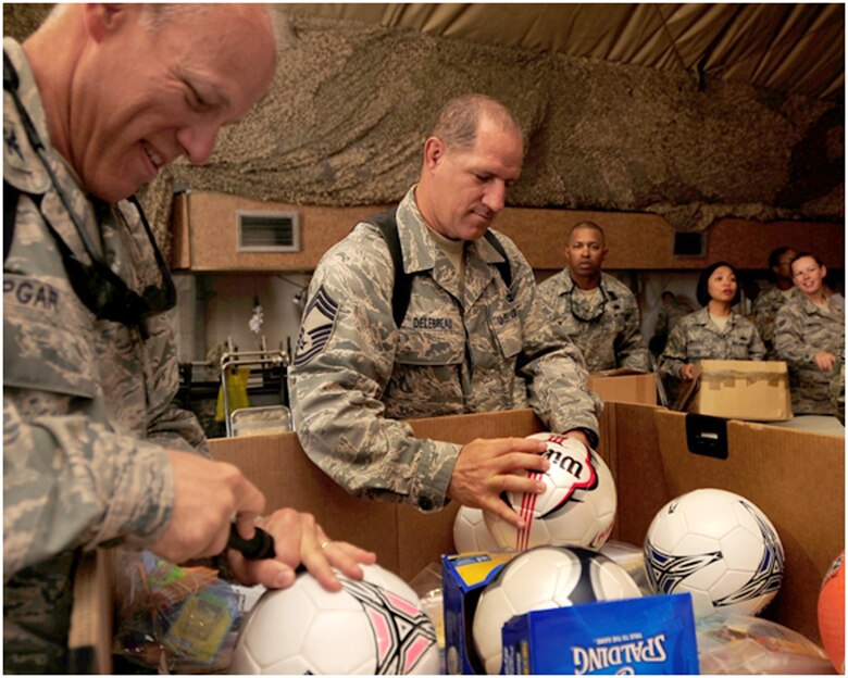 Chief Master Sgt. Gerald Delbreau sorts through toys to deliver to Iraqi children during his deployment to Ali Air Base, Iraq, in 2009. Chief Delebreau served as the Group Superintendent for his group during that deployment and will serve as the first Reserve command chief for his next deployment to Iraq this week. Courtest photo.