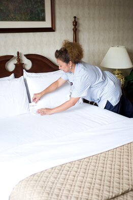 Belma Kadunce, Eagle’s Rest housekeeper, finishes cleaning a room by placing a mint on the pillow May 26, 2011, at Dover Air Force Base, Del. (U.S. Air Force Photo/Steve Kotecki)