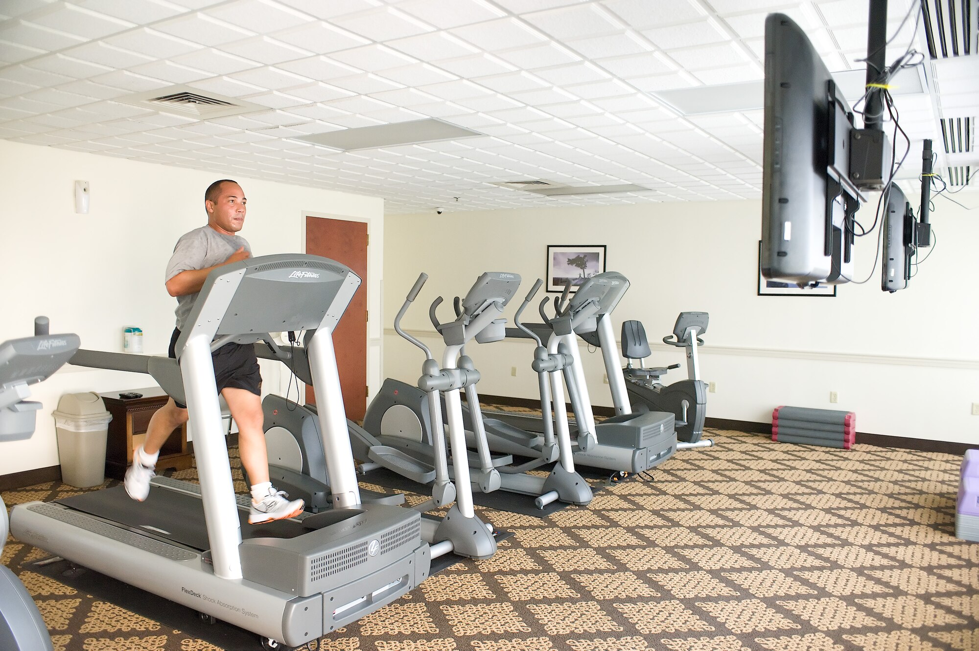 Army Sgt. Luis Burgos, Air Force Mortuary Affairs Operations Center Army liaison case manager, runs on the treadmill in the new fitness facility May 26, 2011, at Eagle’s Rest lodging facility Dover Air Force Base, Del. (U.S. Air Force photo by Steve Kotecki)