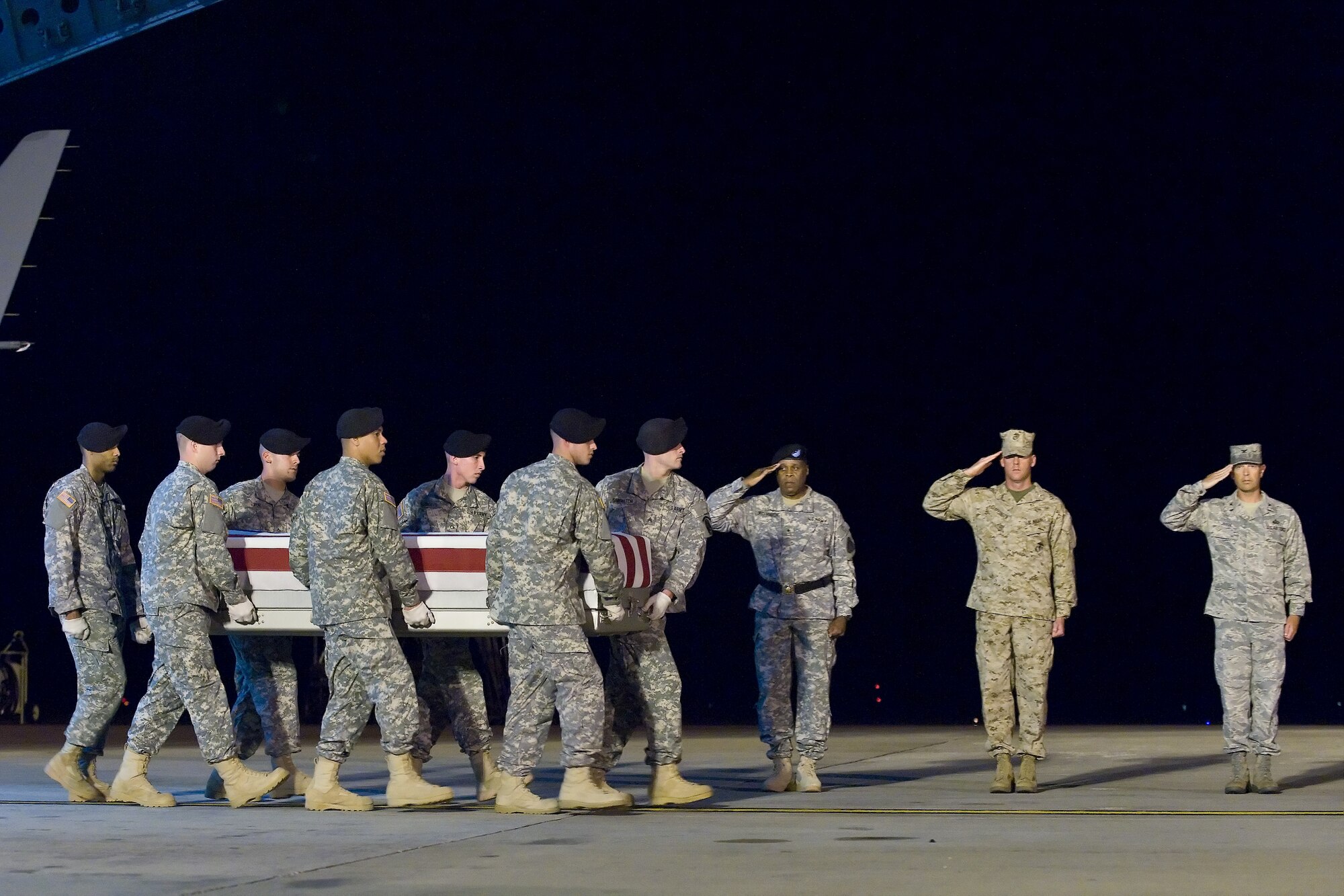 A U.S. Army carry team transfers the remains of Army Spc. Adam S. Hamilton, of Kent, Ohio, at Dover Air Force Base, Del., May 31, 2011. Hamilton was assigned to the 4th Squadron, 4th Cavalry Regiment, 1st Brigade Combat Team, 1st Infantry Division, Fort Riley, Kan. (U.S. Air Force photo/Roland Balik)
