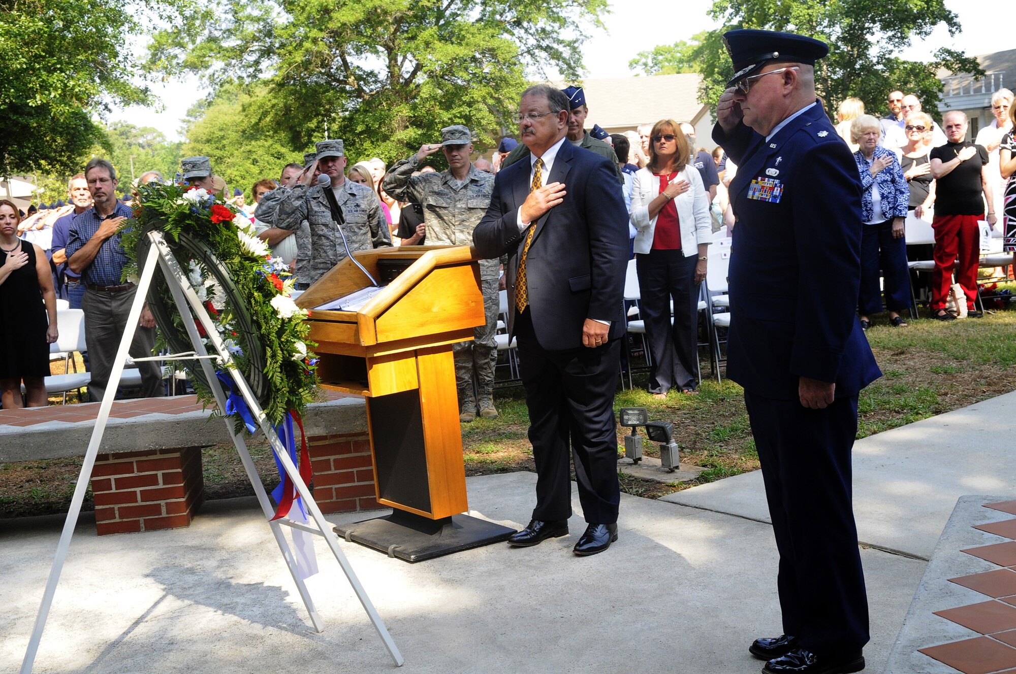 Deryl Israel, WR-ALC executive director, and Chaplain (Lt. Colonel) Kenneth Harp, 78th ABW installation chaplain, officiate the laying of the weath at the Camellia Garden Memorial Service May 26. U. S. Air Force photo by Sue Sapp